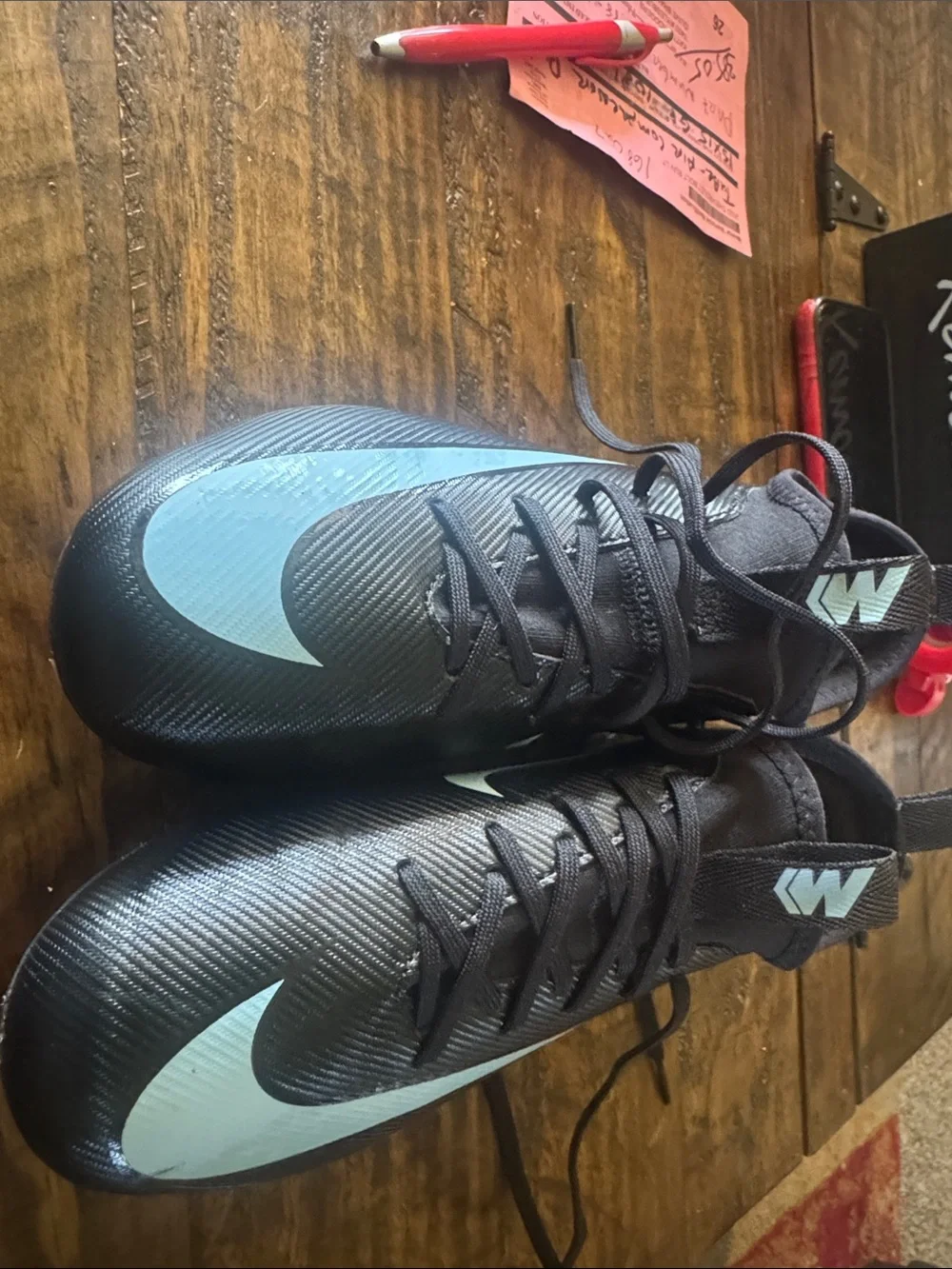 Nike Black Cleats with Light Blue Swoosh